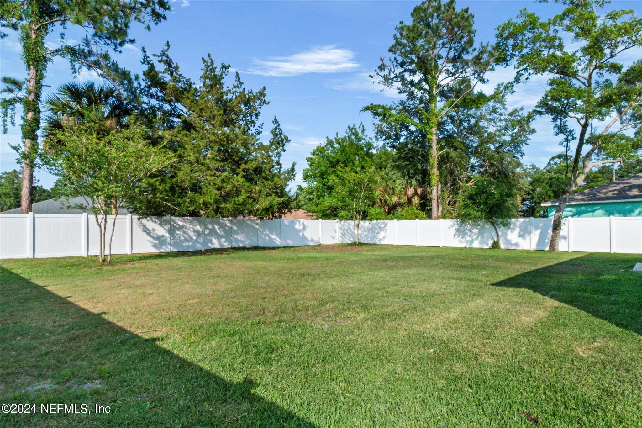 3 Pinwheel Lane Palm Coast, FL 32164 - Photo 19 of 20 a view of a yard with a large trees
