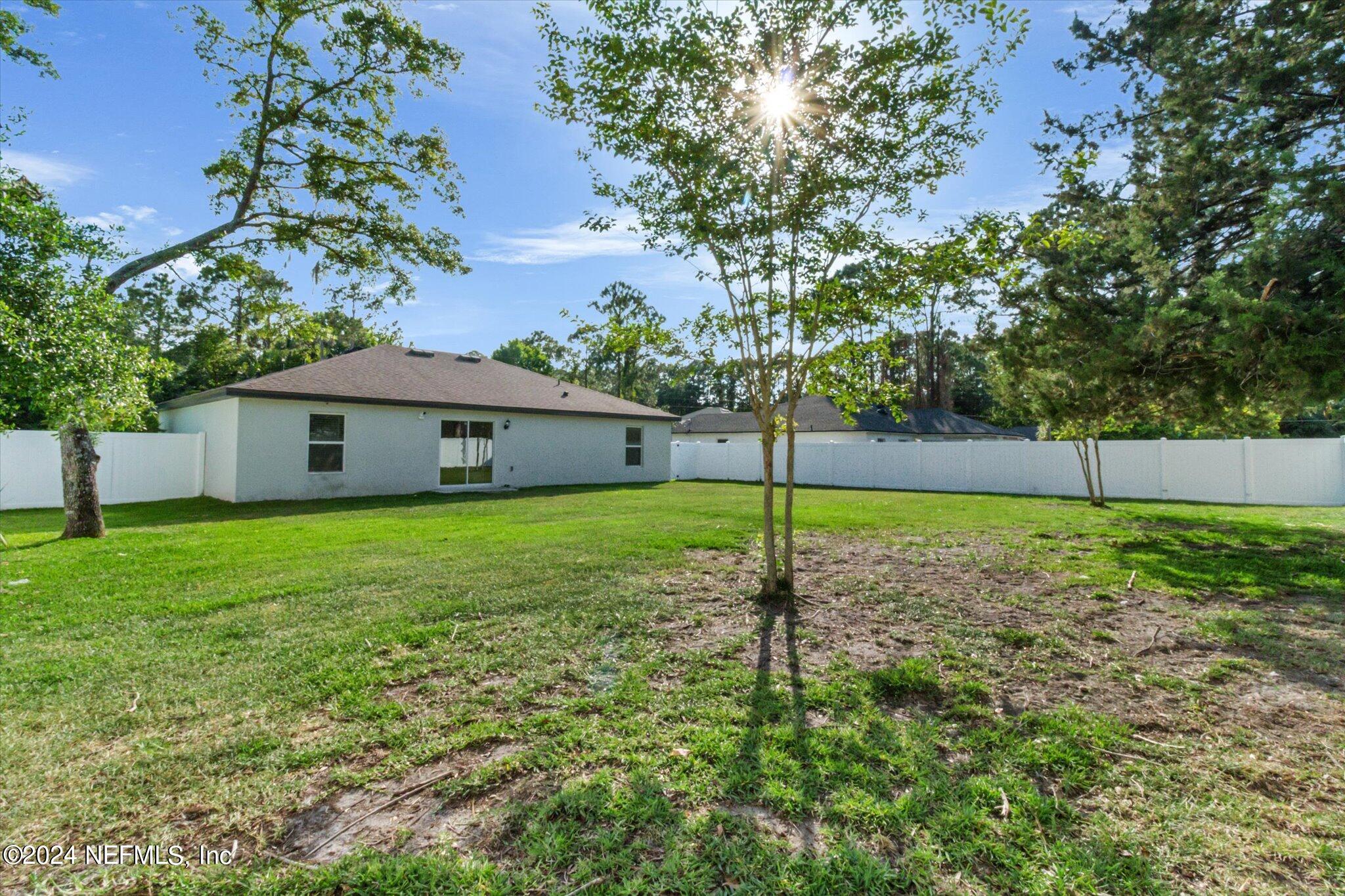 3 Pinwheel Lane Palm Coast, FL 32164 - Photo 20 of 20 a yellow house sitting in middle of the grass
