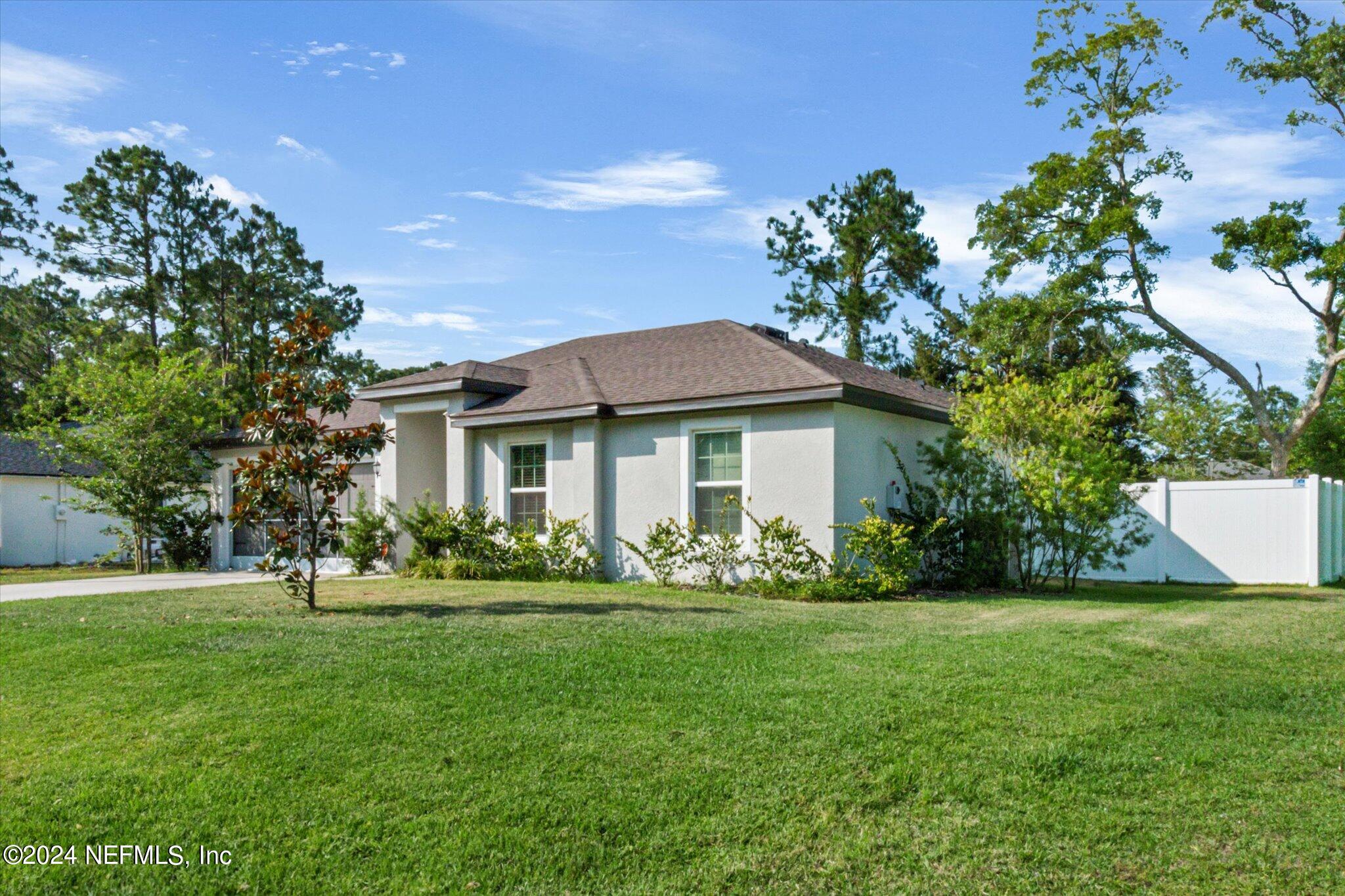 3 Pinwheel Lane Palm Coast, FL 32164 - Photo 2 of 20 a front view of a house with a yard