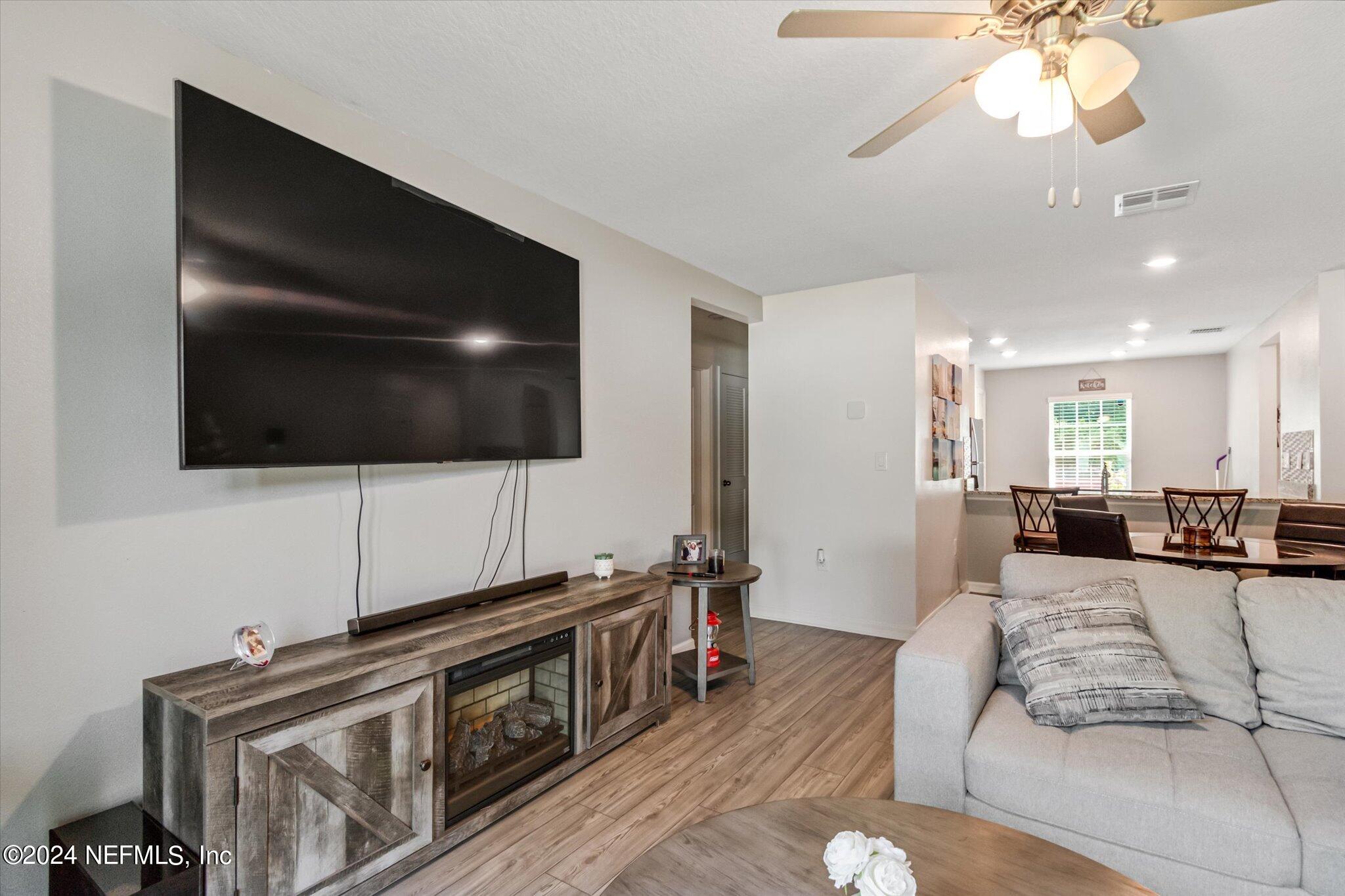 3 Pinwheel Lane Palm Coast, FL 32164 - Photo 8 of 20 a living room with furniture and a flat screen tv