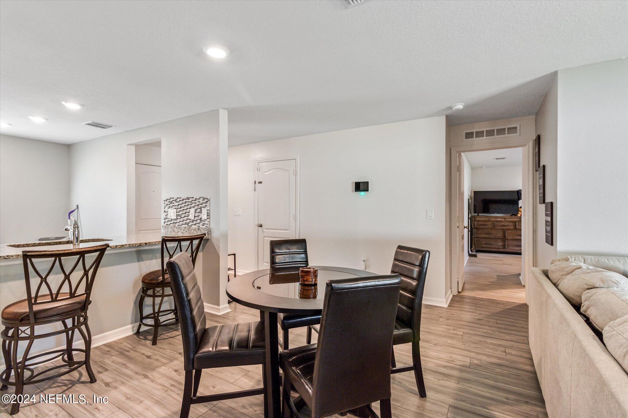3 Pinwheel Lane Palm Coast, FL 32164 - Photo 9 of 20 a view of a dining room with furniture and wooden floor