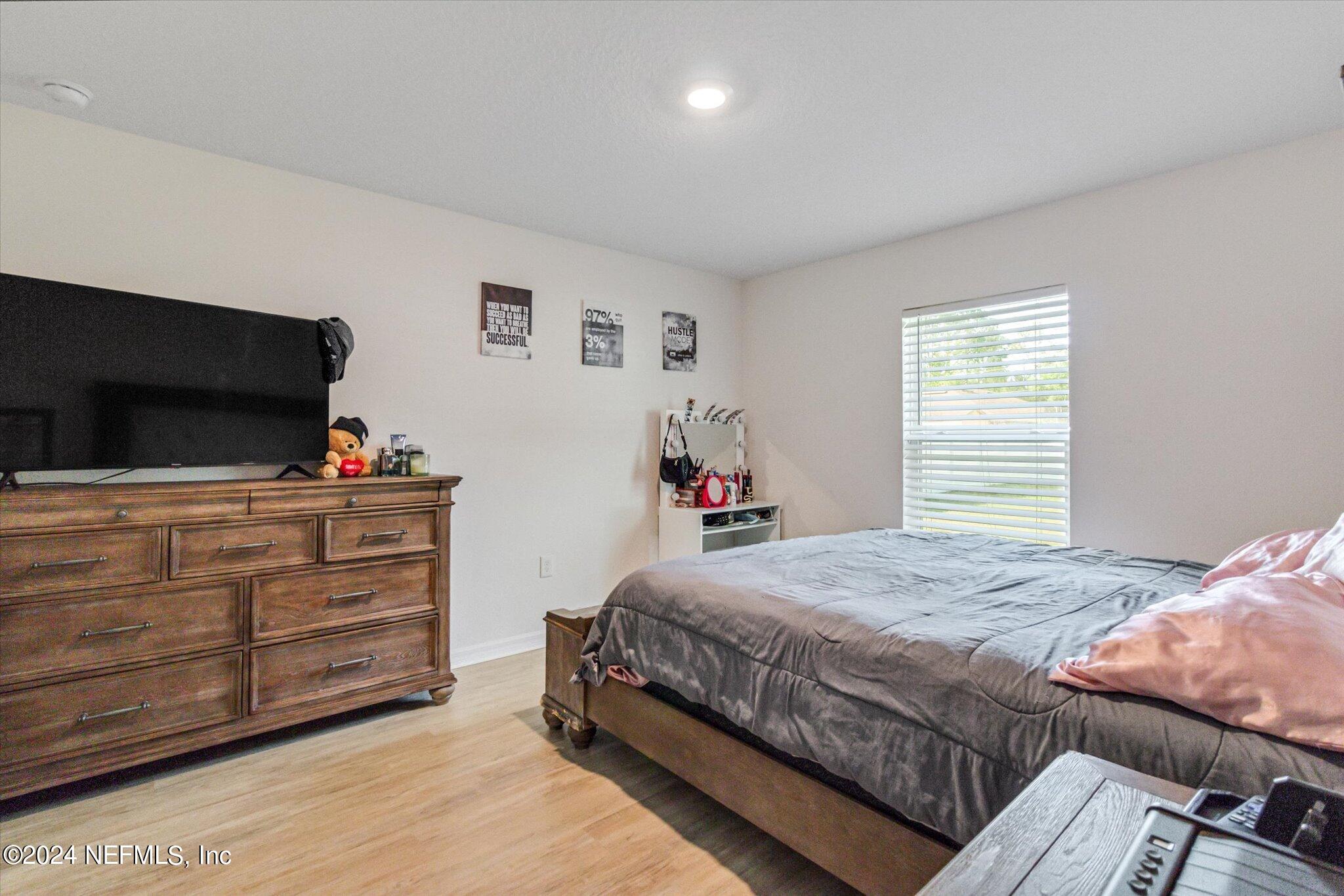 3 Pinwheel Lane Palm Coast, FL 32164 - Photo 10 of 20 a bedroom with a bed and a flat screen tv