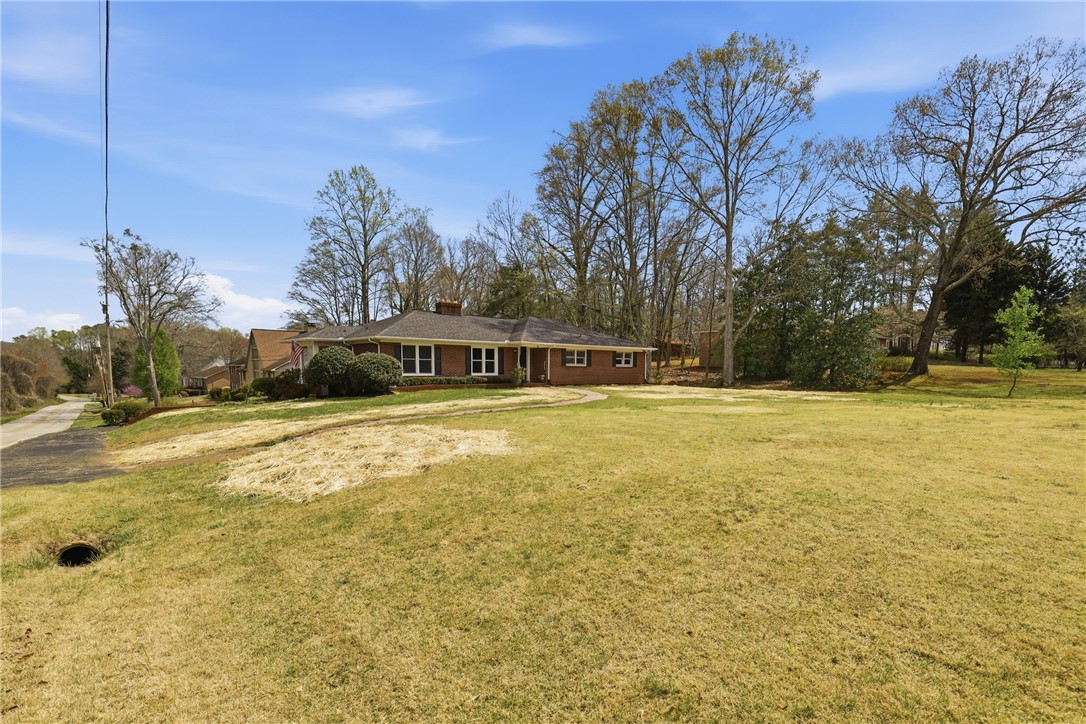 4304 Old Buncombe Road Greenville, SC 29617 - Photo 3 of 49 This brick ranch home features a classic design with expansive outdoor areas.