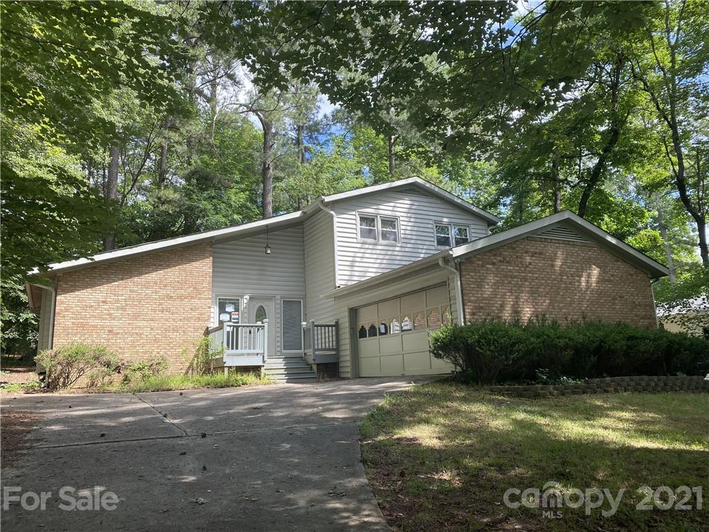6205 Coldwater Court Raleigh, NC 27612 - Photo 1 of 16 a view of a house with a yard plants and large tree