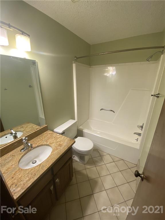 6205 Coldwater Court Raleigh, NC 27612 - Photo 12 of 16 a bathroom with a granite countertop sink toilet and shower