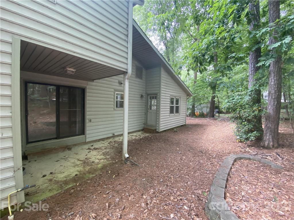 6205 Coldwater Court Raleigh, NC 27612 - Photo 16 of 16 a view of a house with a backyard and garage