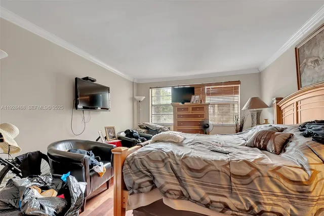a bedroom with a bed and flat screen tv