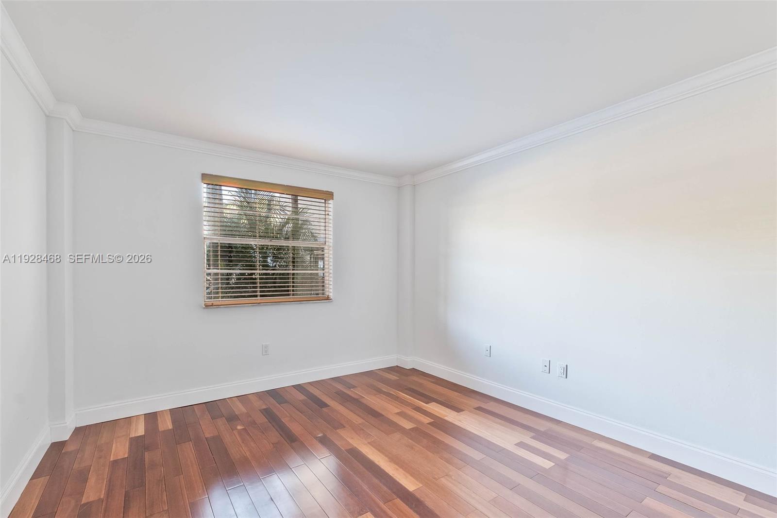 14250 Southwest 62nd Street, Unit 118 Miami, FL 33183 - Photo 15 of 23 an empty room with wooden floor and windows