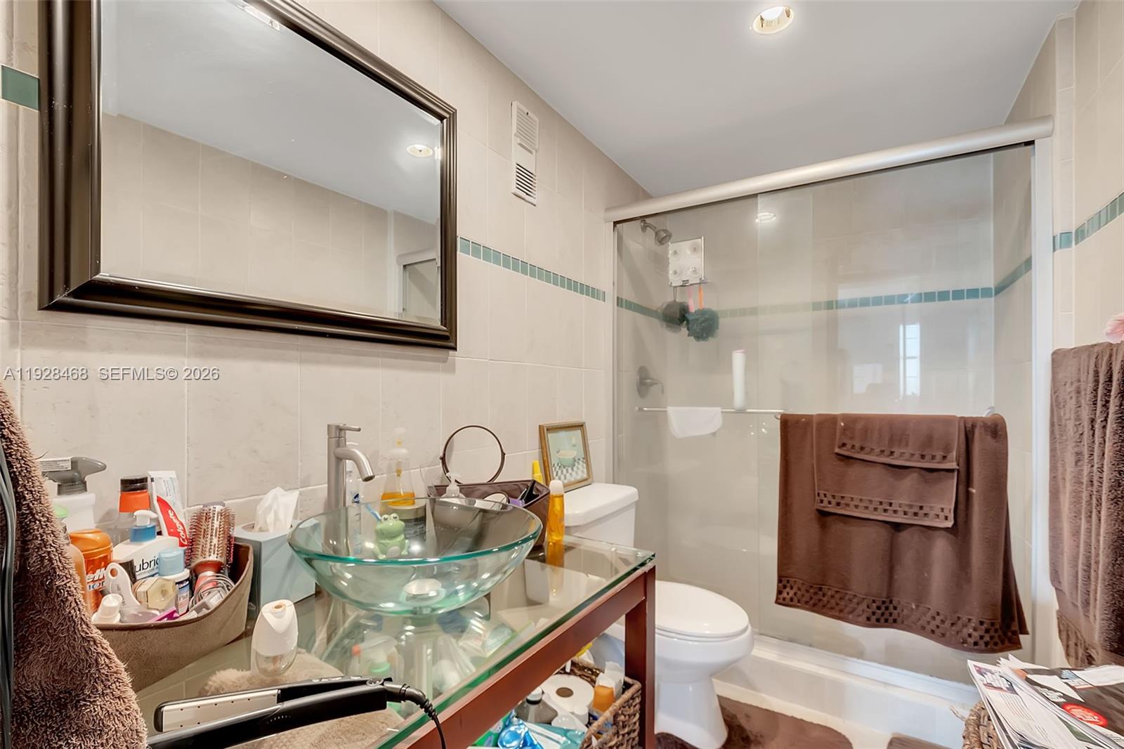 14250 Southwest 62nd Street, Unit 118 Miami, FL 33183 - Photo 7 of 23 a bathroom with a sink a toilet and a mirror