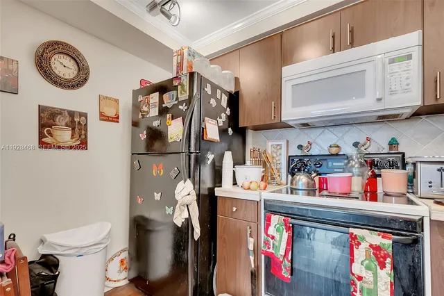 a utility room with lots of clutter and cabinets