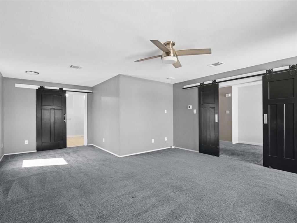 5304 Los Altos Road Fort Worth, TX 76244 - Photo 19 of 30 Unfurnished bedroom featuring a barn door, carpet, and ceiling fan