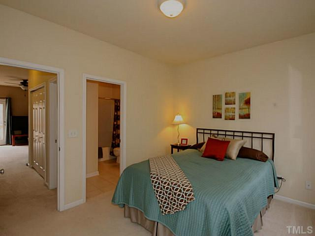 1635 Snow Mass Way Durham, NC 27713 - Photo 11 of 25 a bedroom with a bed and wooden floor