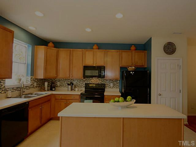 1635 Snow Mass Way Durham, NC 27713 - Photo 15 of 25 a kitchen with a refrigerator and a sink