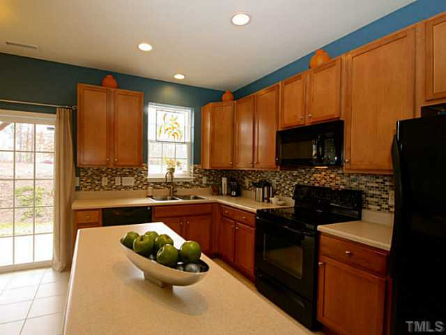 1635 Snow Mass Way Durham, NC 27713 - Photo 3 of 25 a kitchen with a sink a microwave a stove and refrigerator