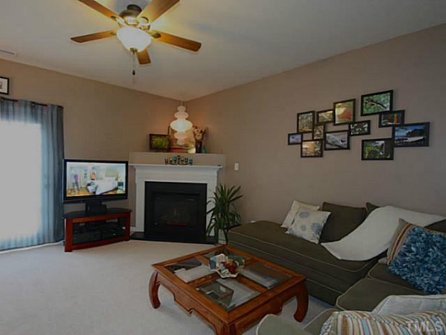 1635 Snow Mass Way Durham, NC 27713 - Photo 7 of 25 a living room with furniture and a fireplace