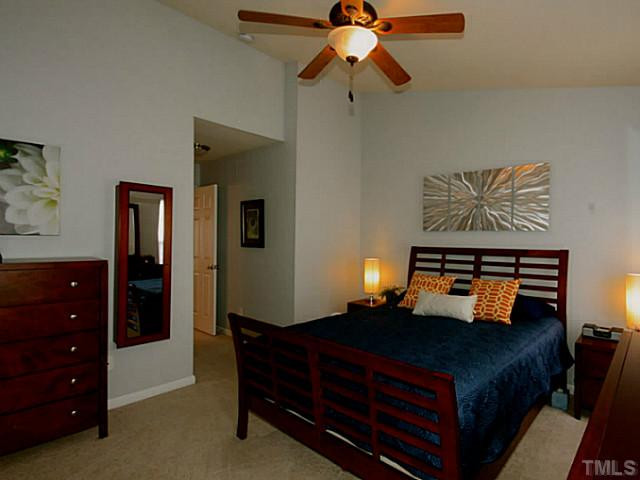 1635 Snow Mass Way Durham, NC 27713 - Photo 9 of 25 a bedroom with a bed and a chandelier