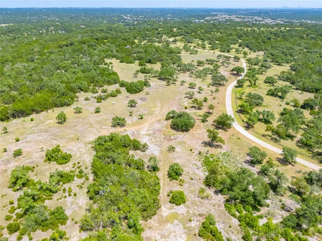 a view of a big yard with lots of green space