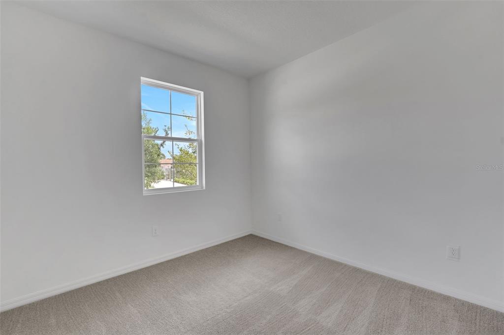 35424 Tuscan Hill Road Dade City, FL 33525 - Photo 11 of 42 an empty room with a window