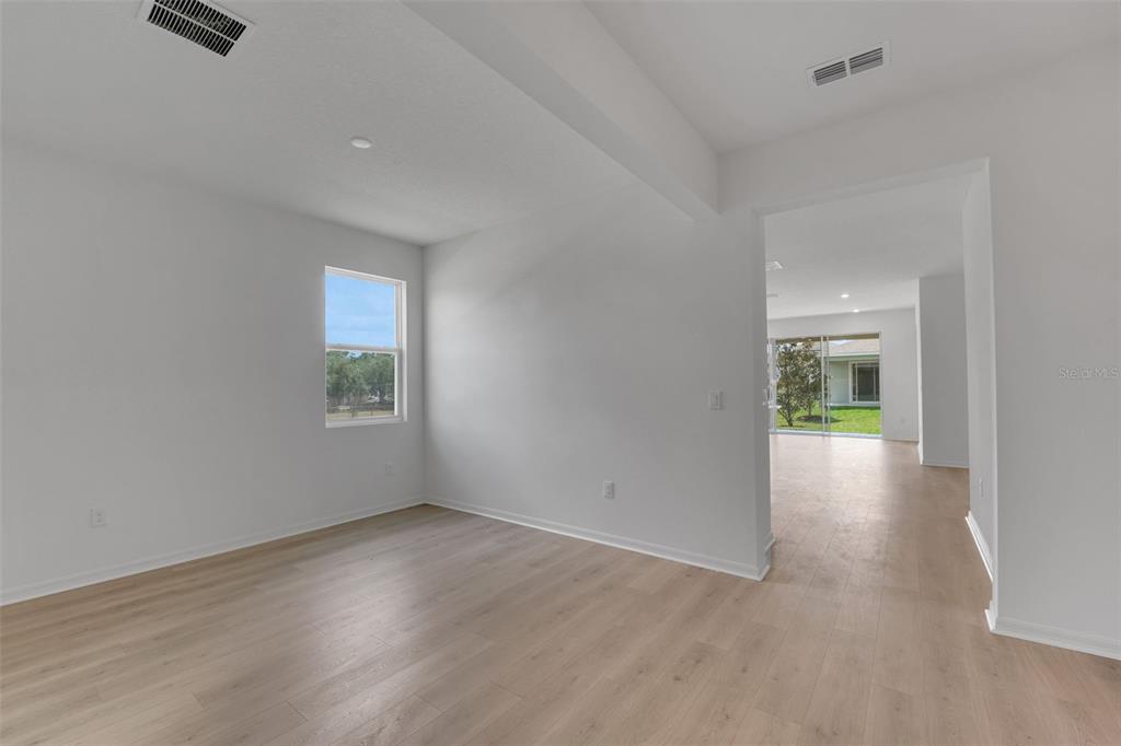 35424 Tuscan Hill Road Dade City, FL 33525 - Photo 13 of 42 an empty room with windows and entrance