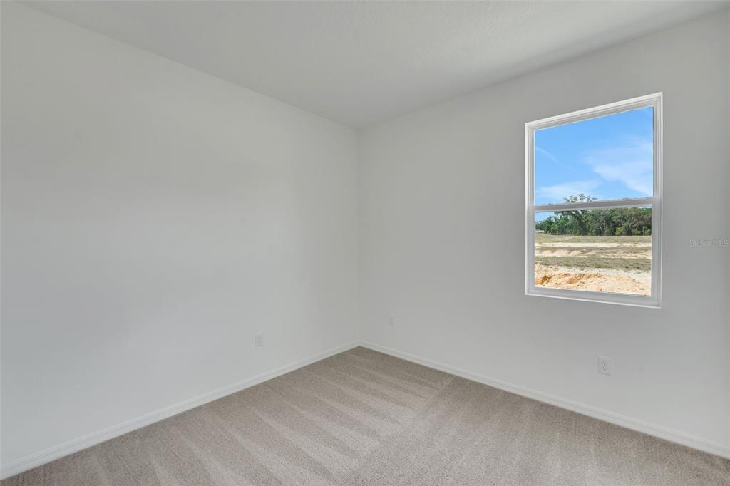 35424 Tuscan Hill Road Dade City, FL 33525 - Photo 25 of 42 an empty room with a window