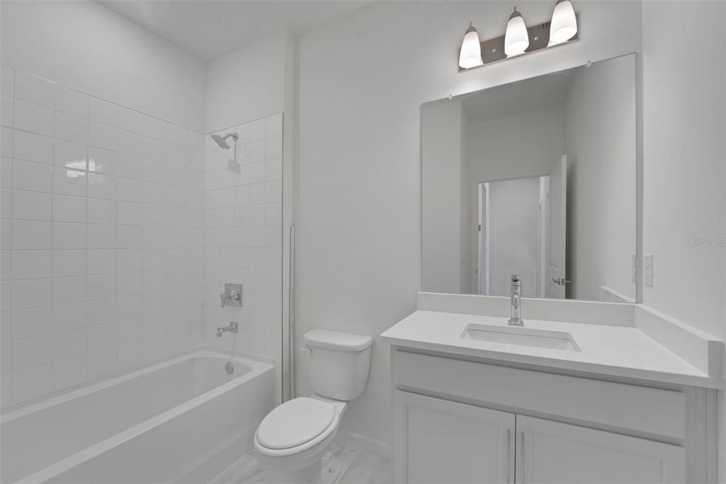 35424 Tuscan Hill Road Dade City, FL 33525 - Photo 29 of 42 a bathroom with a sink toilet and shower