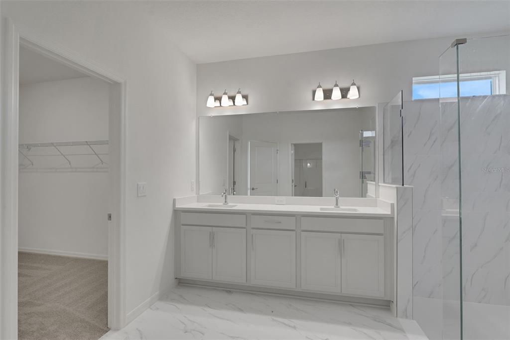 35424 Tuscan Hill Road Dade City, FL 33525 - Photo 37 of 42 a bathroom with a sink and a mirror