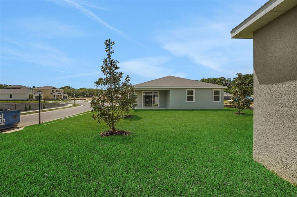35424 Tuscan Hill Road Dade City, FL 33525 - Photo 39 of 42 a house view with garden space and trees