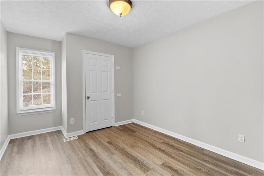 3483 Kingswood Run Decatur, GA 30034 - Photo 14 of 19 an empty room with wooden floor and windows