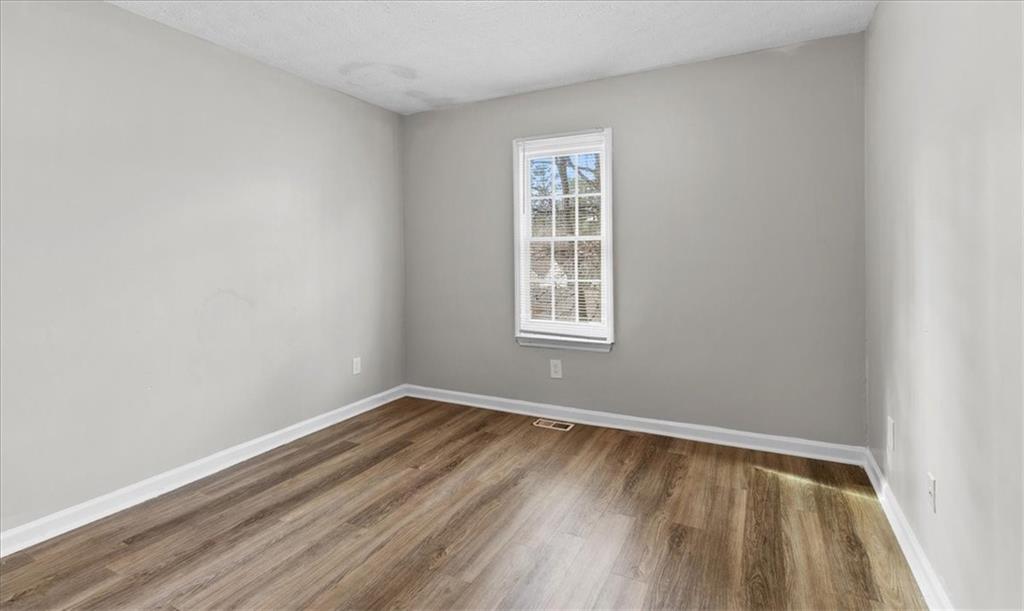 3483 Kingswood Run Decatur, GA 30034 - Photo 15 of 19 wooden floor in an empty room with a window