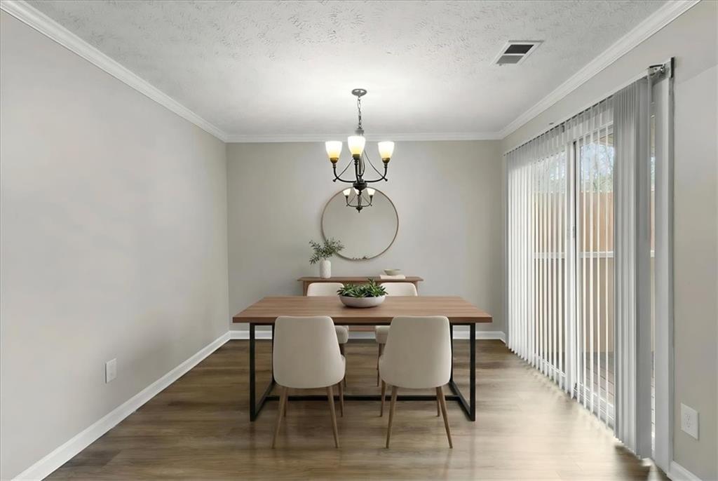 3483 Kingswood Run Decatur, GA 30034 - Photo 7 of 19 a dining room with furniture a chandelier and wooden floor
