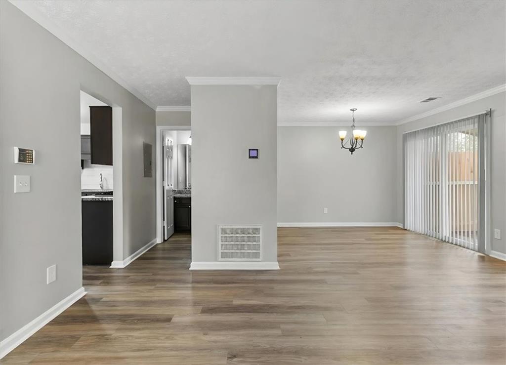 3483 Kingswood Run Decatur, GA 30034 - Photo 8 of 19 a view of an empty room with wooden floor and a kitchen