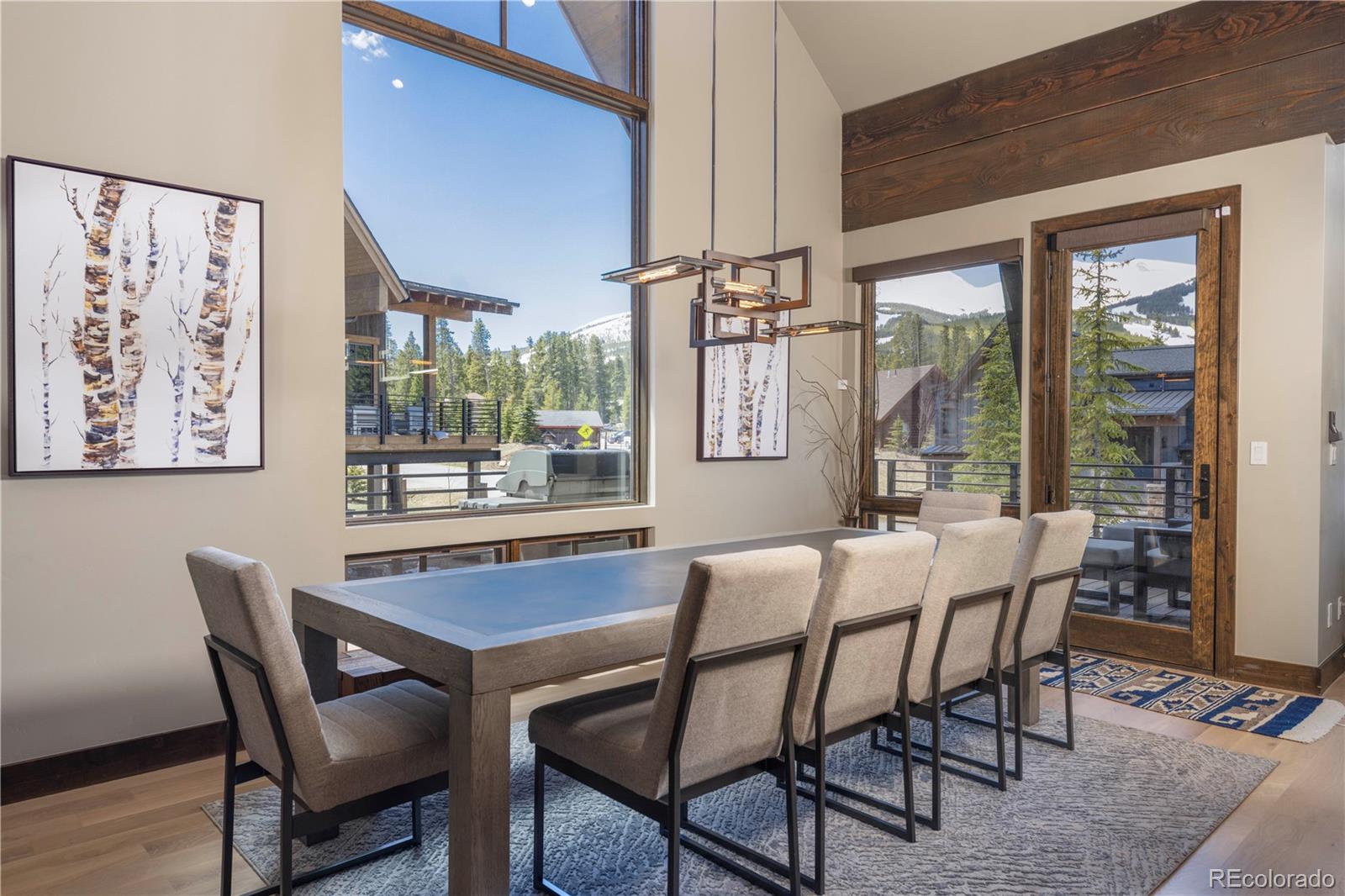 92 Cucumber Creek Road Breckenridge, CO 80424 - Photo 12 of 37 a dining room with furniture a chandelier and wooden floor