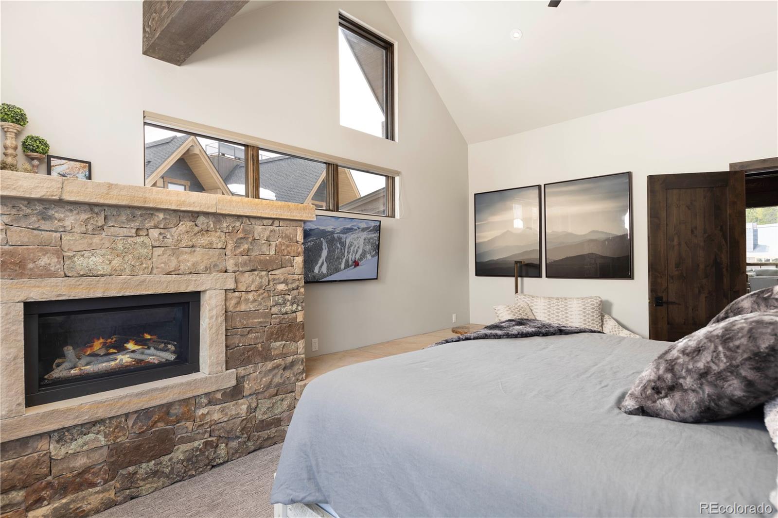 92 Cucumber Creek Road Breckenridge, CO 80424 - Photo 17 of 37 a bedroom with a bed and a fireplace