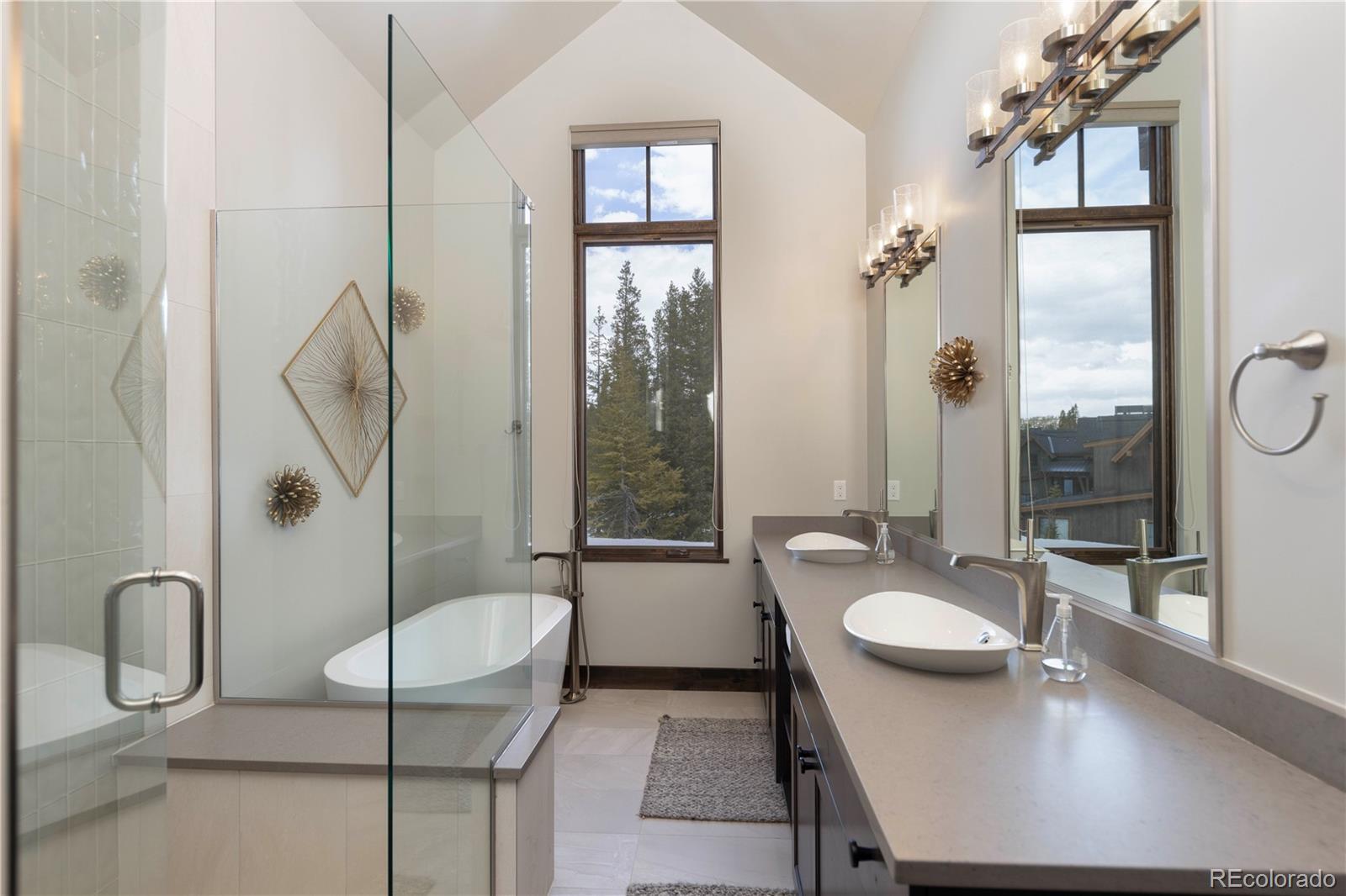 92 Cucumber Creek Road Breckenridge, CO 80424 - Photo 18 of 37 a bathroom with a granite countertop sink a mirror and a bath tub