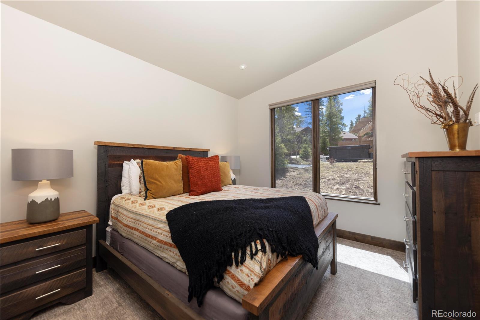 92 Cucumber Creek Road Breckenridge, CO 80424 - Photo 24 of 37 a bedroom with a bed and wooden floor