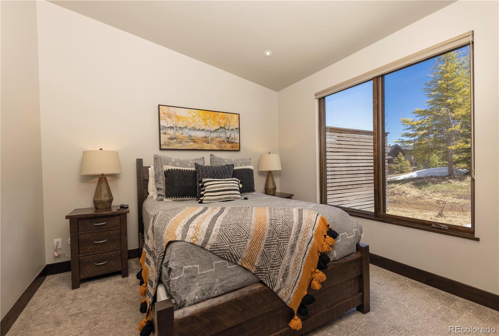 92 Cucumber Creek Road Breckenridge, CO 80424 - Photo 27 of 37 a bedroom with a bed and wooden floor
