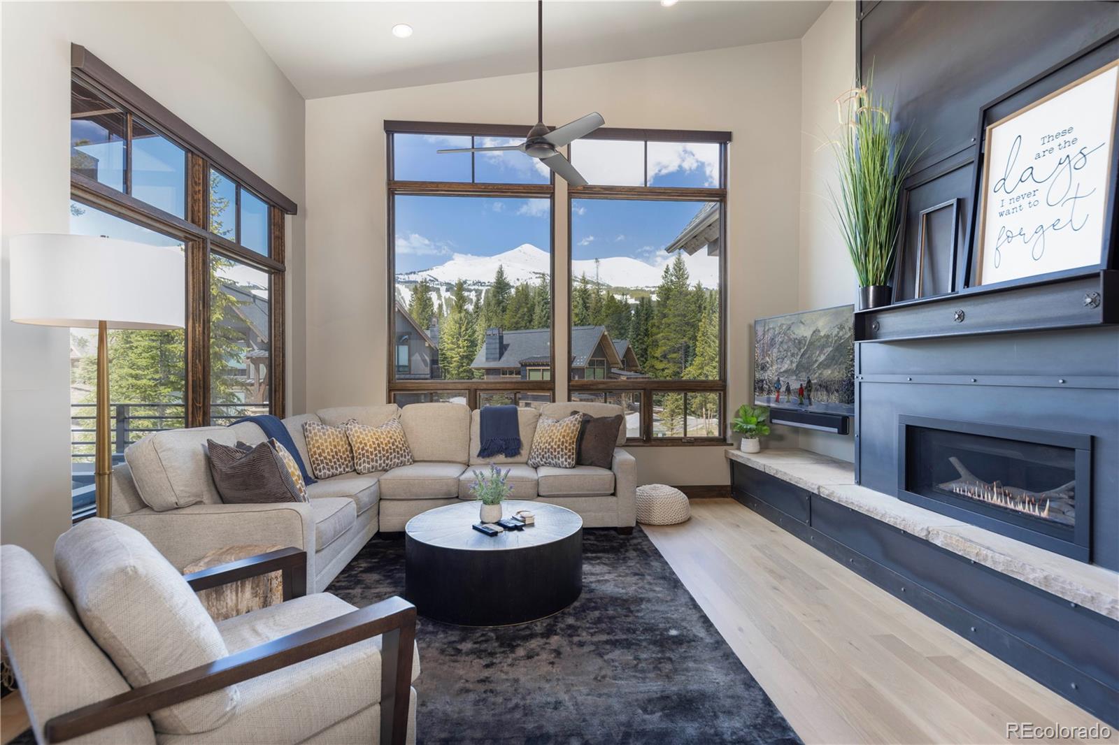 92 Cucumber Creek Road Breckenridge, CO 80424 - Photo 5 of 37 a living room with furniture a fireplace and a floor to ceiling window