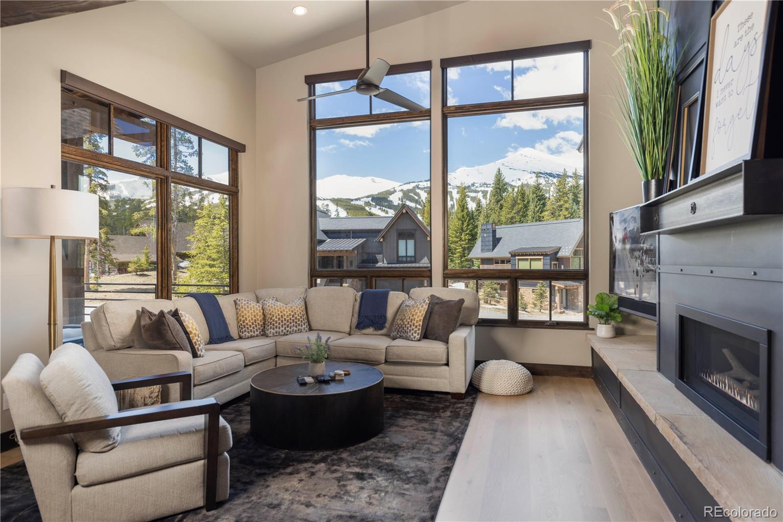 92 Cucumber Creek Road Breckenridge, CO 80424 - Photo 6 of 37 a living room with furniture large windows and a fireplace