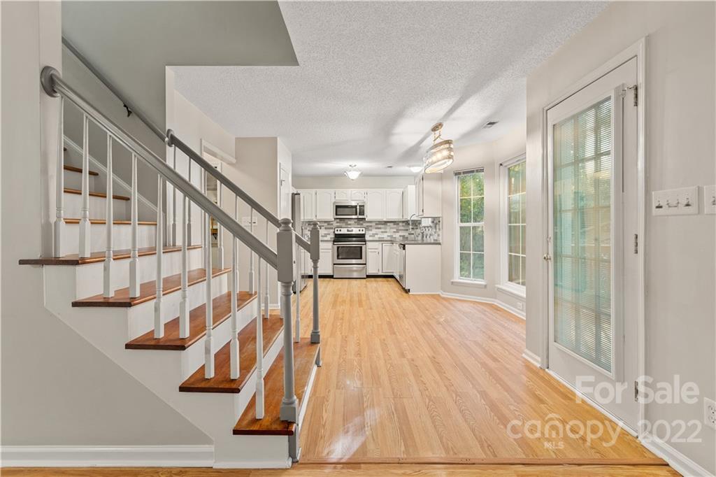 a view of entryway and hall with wooden floor