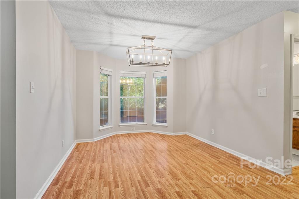 12021 Danby Road Pineville, NC 28134 - Photo 12 of 27 a view of empty room with wooden floor and fan