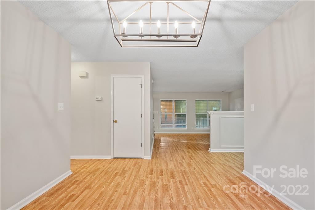 12021 Danby Road Pineville, NC 28134 - Photo 13 of 27 a view of empty room with wooden floor