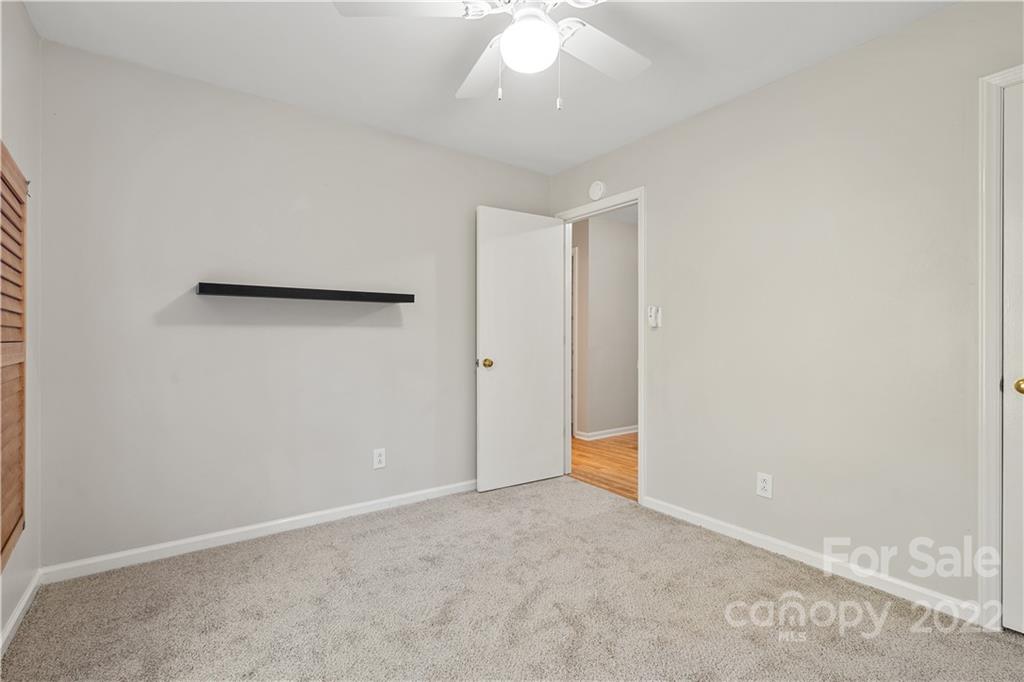 12021 Danby Road Pineville, NC 28134 - Photo 17 of 27 an empty room with a ceiling fan