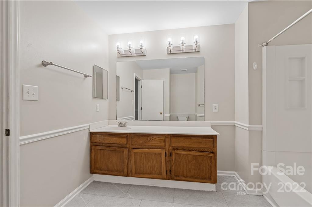 12021 Danby Road Pineville, NC 28134 - Photo 19 of 27 a bathroom with a double vanity sink and a mirror