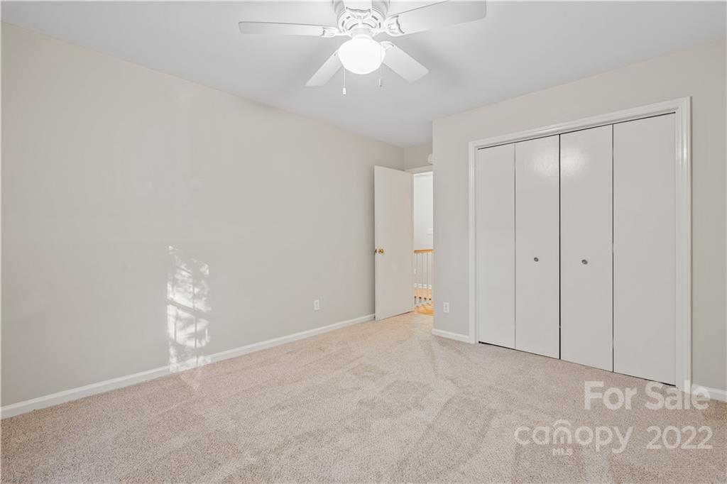 12021 Danby Road Pineville, NC 28134 - Photo 21 of 27 a view of an empty room with a ceiling fan