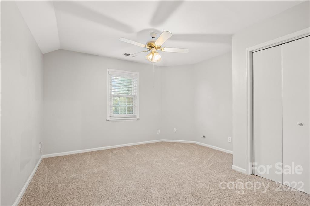 12021 Danby Road Pineville, NC 28134 - Photo 24 of 27 an empty room with a window and a fan