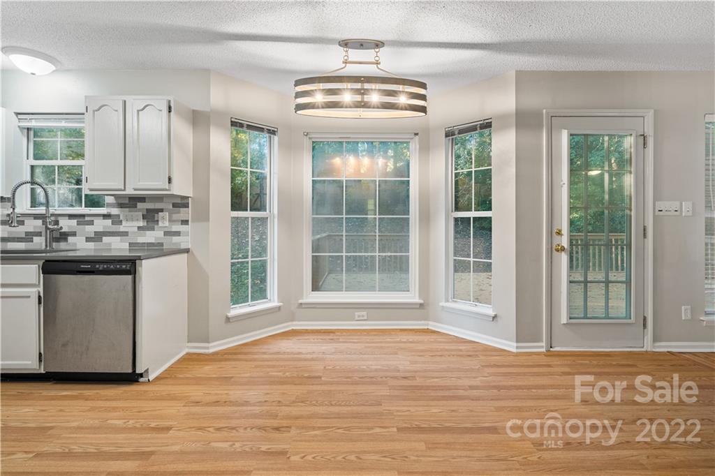 12021 Danby Road Pineville, NC 28134 - Photo 5 of 27 a view of a kitchen with a sink and dishwasher kitchen view
