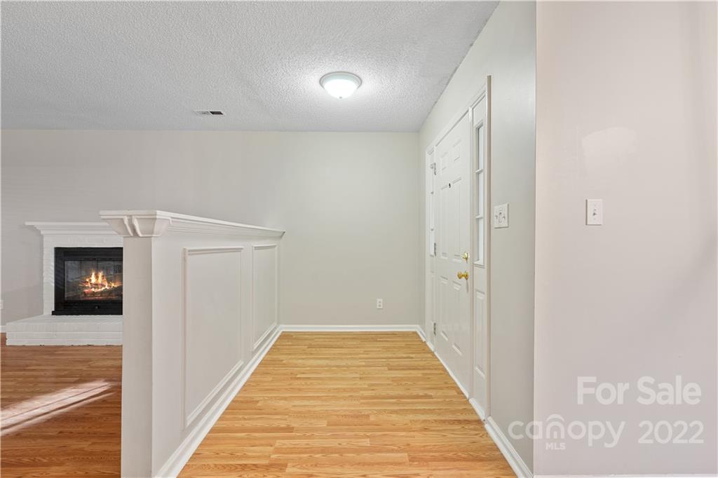 12021 Danby Road Pineville, NC 28134 - Photo 9 of 27 a view of a hallway with wooden floor and a hallway