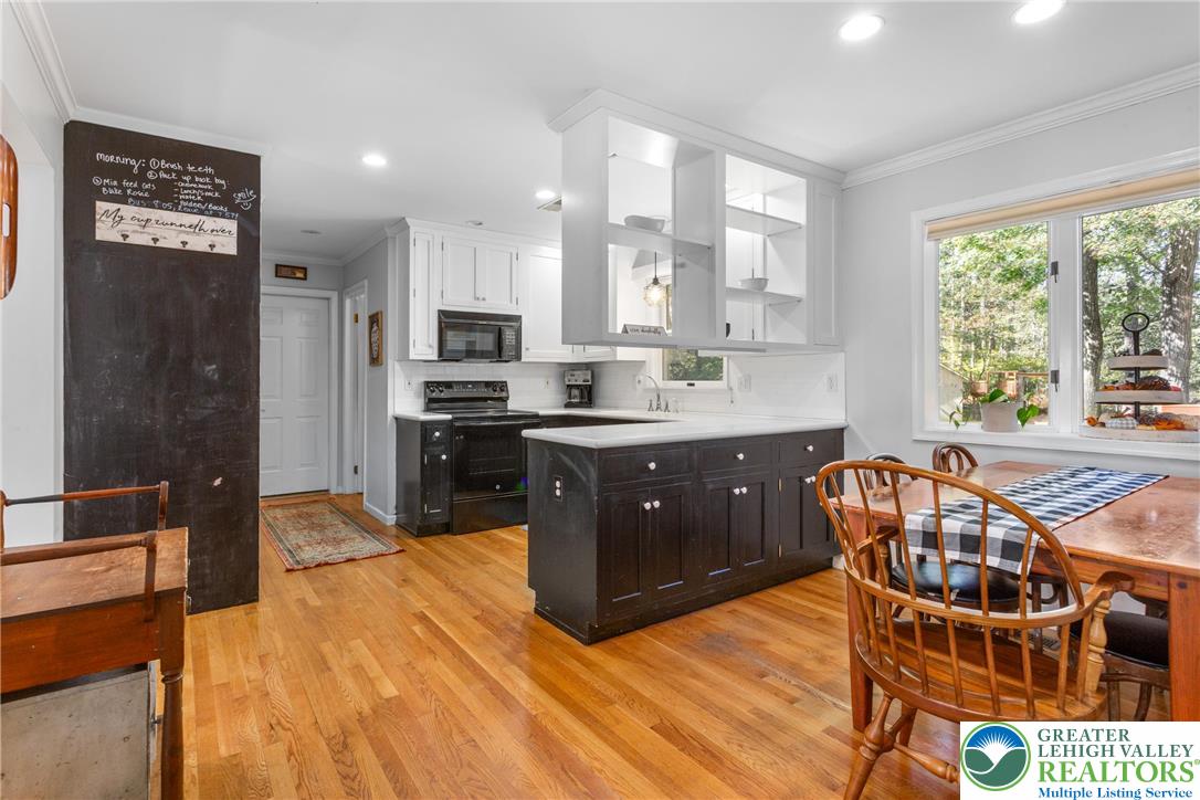 569 Pine Tree Drive Nazareth, PA 18064 - Photo 13 of 29 a kitchen with stainless steel appliances granite countertop a sink a stove a refrigerator cabinets and a dining table