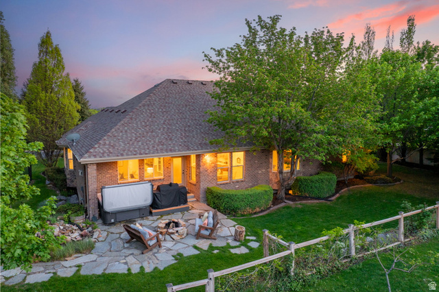 6208 West Bull River Road Highland, UT 84003 - Photo 64 of 90 Rear exterior featuring brick siding, an expansive flagstone patio, and a fire pit area