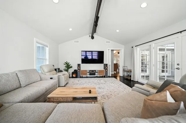 a living room with furniture ceiling fan and a rug